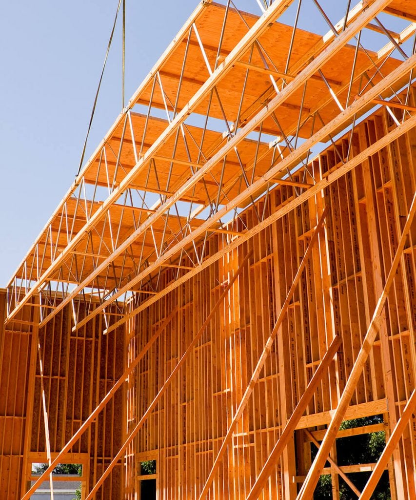 long span open web trusses being modularly installed via crane
