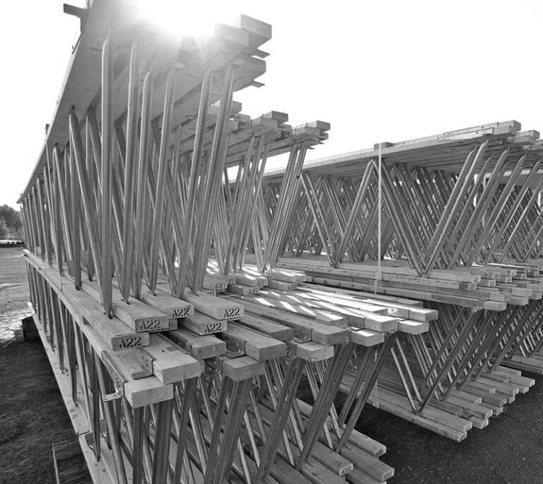 A black and white photo of RedBuilt trusses sitting in the sunlight