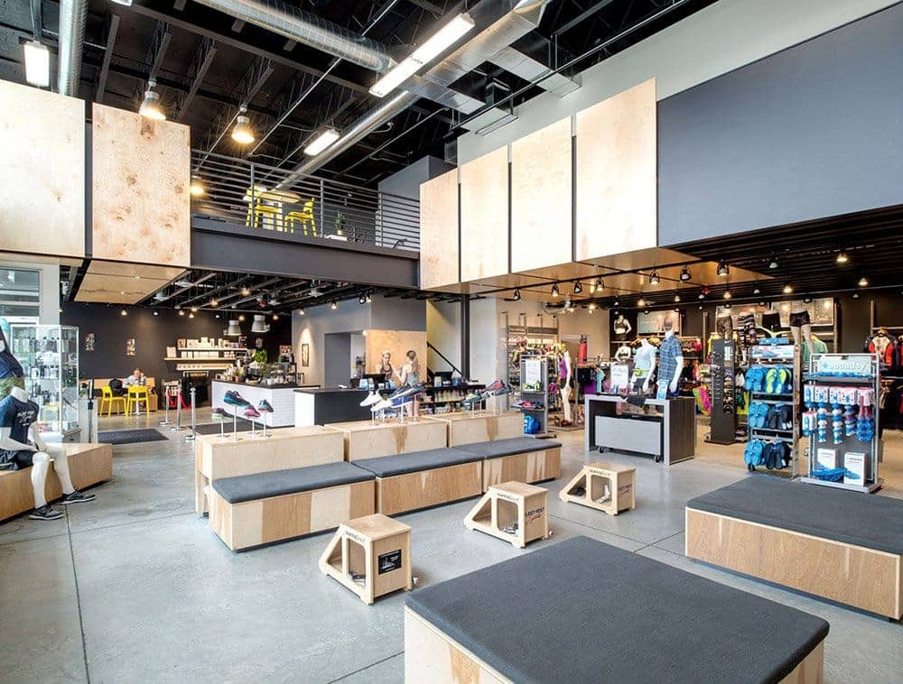 Stylish black open web trusses are displayed overhead in a retail setting