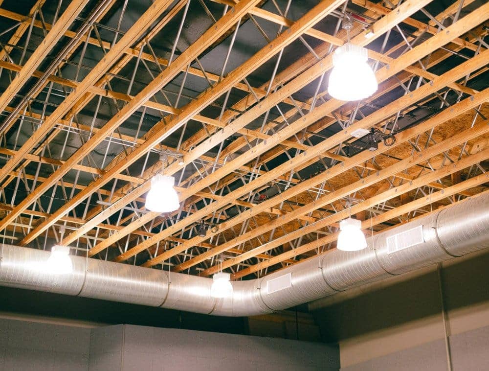 A church auditorium ceiling shows exposed open web trusses