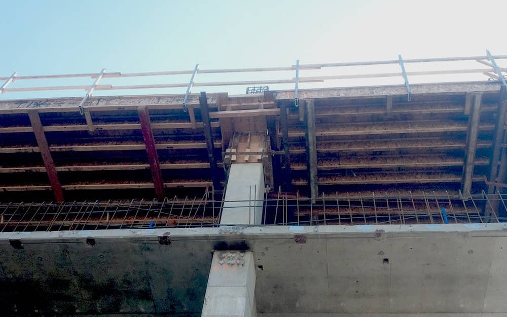 A look upward at the progress in a construction site for a parking garage