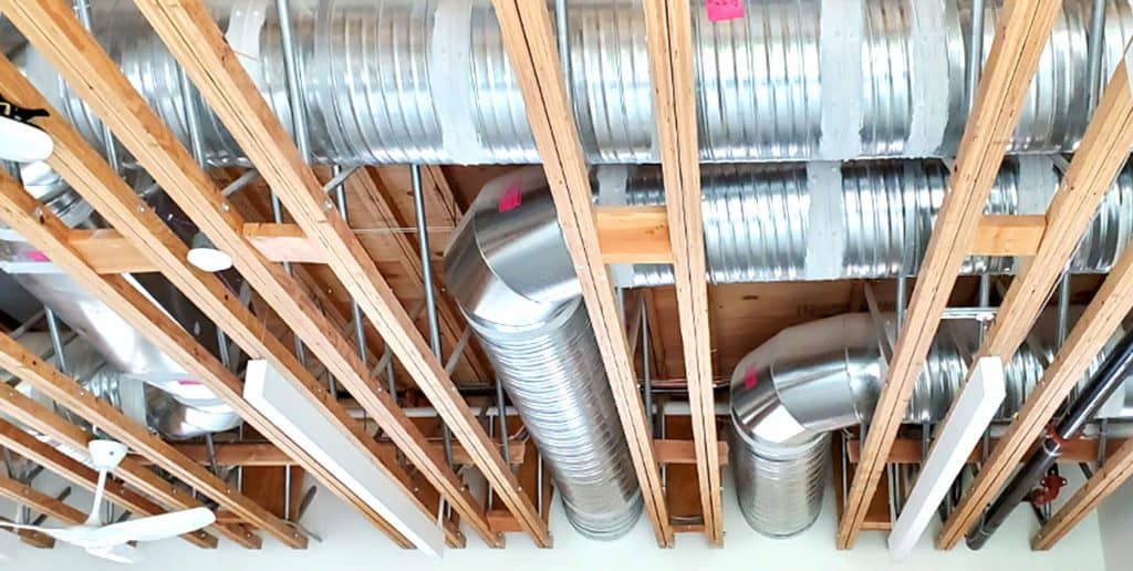 Exposed engineered wood products sit next metallic HVAC