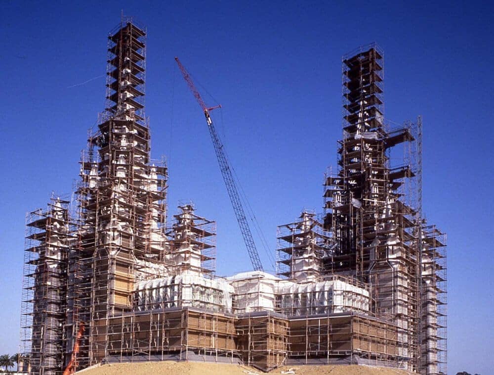 A structure is being build with scaffold planks all around it