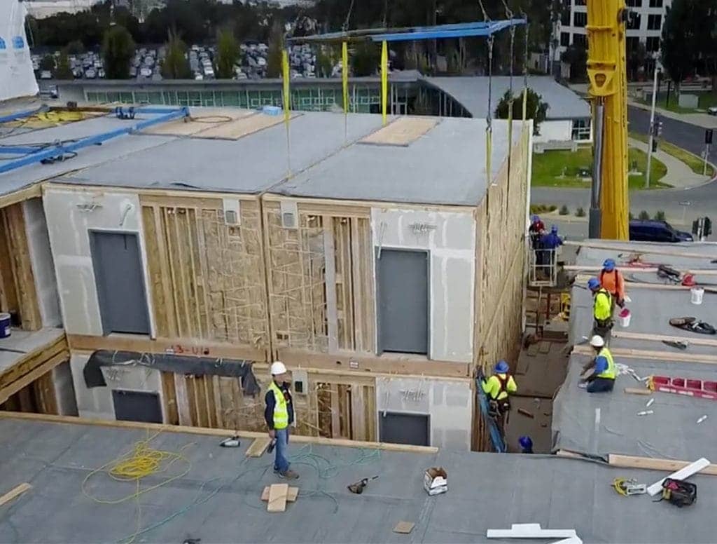 Construction workers checking out something that was made off site