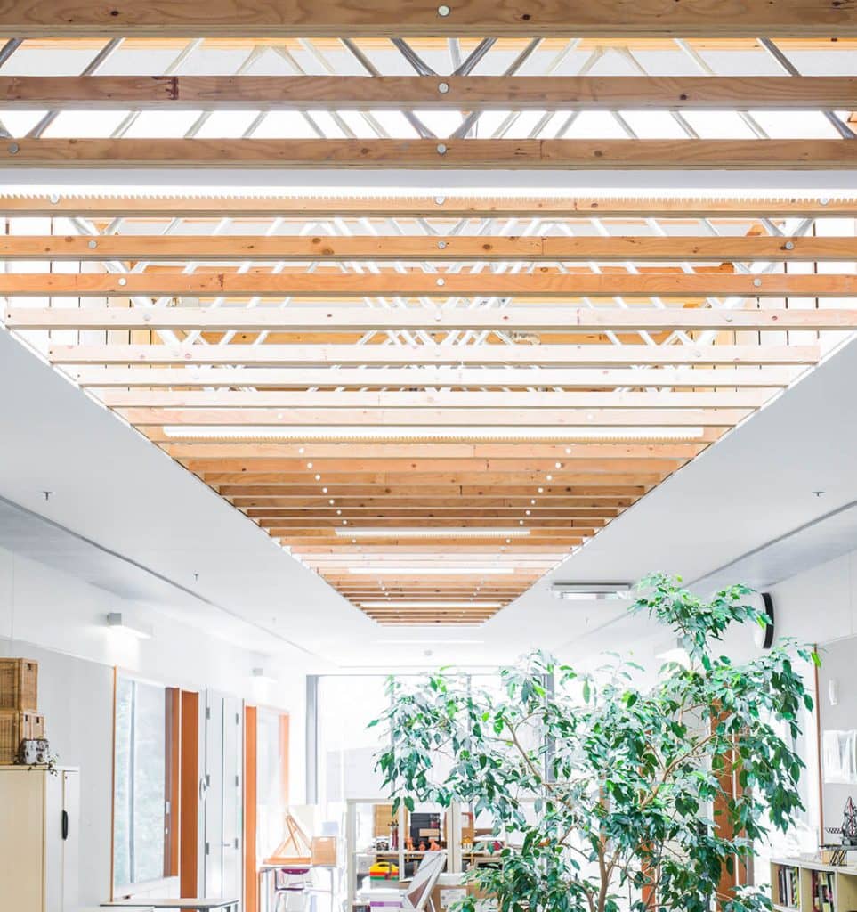 A row of roof trusses in a light and airy space