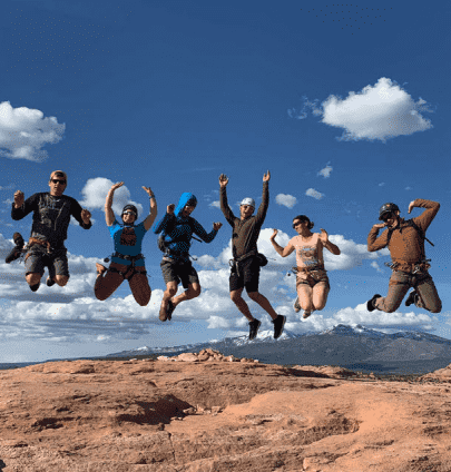RedBuilt team members jump in front of a camera at an outing