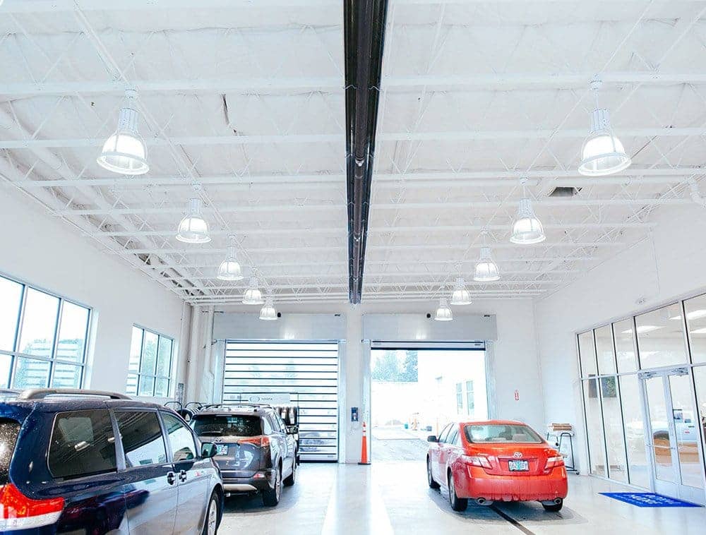 White Tapered Open Web Trusses in a garage with three cars