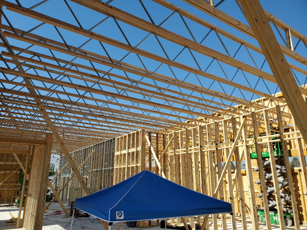 building under construction with exposed open web trusses