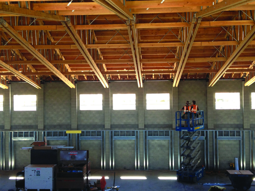 interior of school with exposed open web scissor trusses