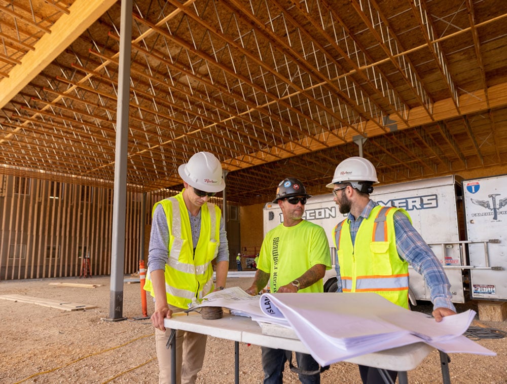 RedBuilt reps and contractor looking at plans on a job site
