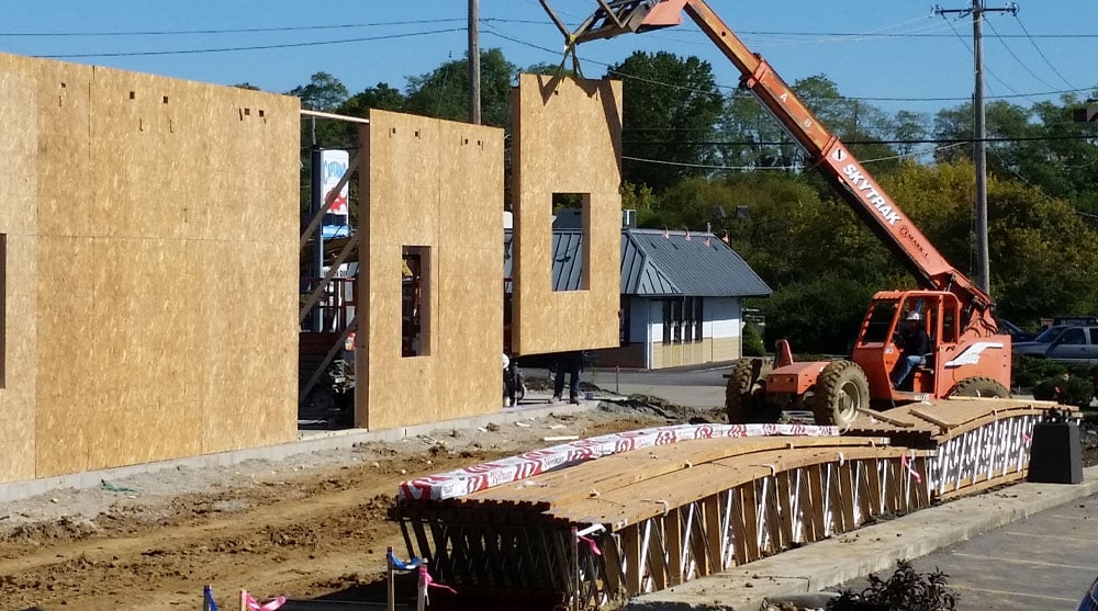 image of wall panels being installed via crane