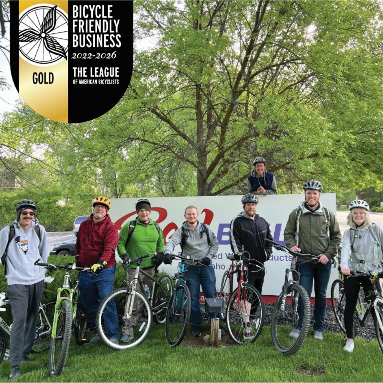Group of RedBuilt associates with bikes and the gold bike friendly business logo overlayed